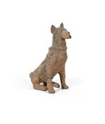 A large pottery model of a seated dog