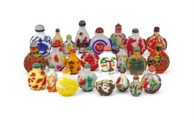 A large group of twenty four Chinese overlaid glass snuff bottles