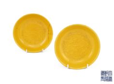 A pair of Chinese yellow-glazed incised 'dragon' saucer dishes