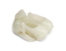A Chinese white jade carving of tree shrew playing with two shoes
