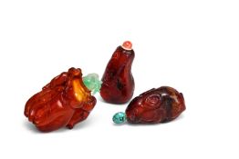 Y Three Chinese carved amber snuff bottles