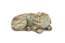 A Chinese celadon and brown jade model of a recumbent Buddhist lion