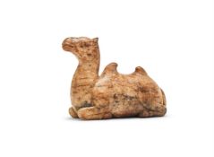 A large Chinese carved white and russet jade camel