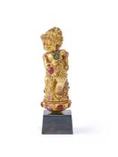 A Balinese gem-set gold coloured chased kris hilt