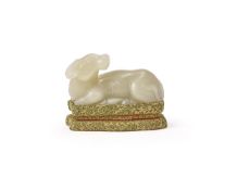 A Chinese pale celadon jade model of a recumbent buffalo