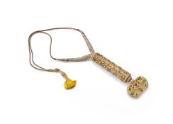 A gem-set jade knife handle and pendant combined as a necklace