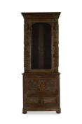 A VICTORIAN CARVED OAK BOOKCASE CABINET IN ANTIQUARIAN TASTE