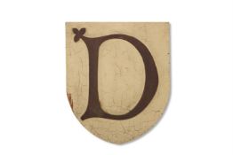 A WHITE PAINTED AND LACQUERED SHIELD SHAPED SIGN, EARLY 20TH CENTURY