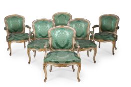 A SET OF SIX GEORGE III WHITE PAINTED AND PARCEL GILT ARMCHAIRS, CIRCA 1770