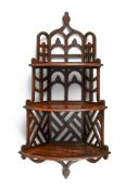 A SET OF GEORGE III MAHOGANY AND FRETWORK HANGING SHELVES, CIRCA 1810