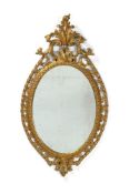 A FINE GEORGE III CARVED GILTWOOD OVAL MIRROR, IN THE MANNER OF THOMAS CHIPPENDALE, CIRCA 1770
