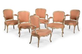 A SET OF SIX GEORGE III CREAM PAINTED AND PARCEL GILT ARMCHAIRS, CIRCA 1775