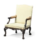 A CARVED MAHOGANY AND UPHOLSTERED ARMCHAIR, PROBABLY LATE 19TH CENTURY