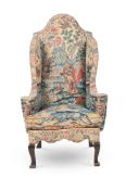 A FINE AND RARE QUEEN ANNE NEEDLEWORK WALNUT AND BEECHWOOD WING ARMCHAIR, CIRCA 1710-1715