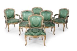 A SET OF SIX GEORGE III WHITE PAINTED AND PARCEL GILT ARMCHAIRS, CIRCA 1770