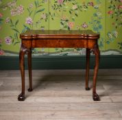 Y A GEORGE II FIGURED WALNUT AND FEATHERBANDED GAMES TABLE, IN THE MANNER OF BENJAMIN COOK