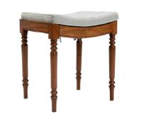 A REGENCY MAHOGANY SADDLE-SEAT STOOL ON TURNED LEGS, CIRCA 1820