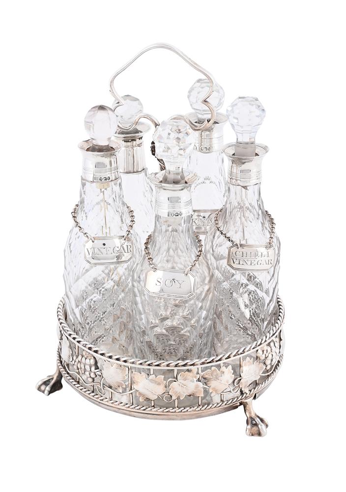A SILVER FIVE BOTTLE CRUET STAND
