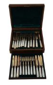 Y A CASED SET OF TWELVE VICTORIAN SILVER GILT AND MOTHER OF PEARL HANDLED FRUIT KNIVES AND FORKS