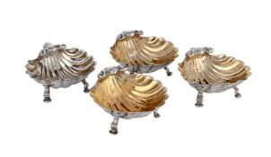 A SET OF FOUR GEORGE III SILVER & PARCEL GILT SHELL SHAPED DISHES