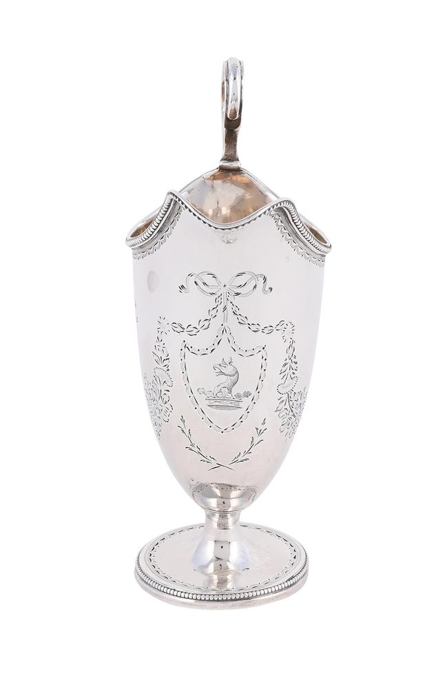A GEORGE III SILVER HELMET SHAPED CREAM JUG