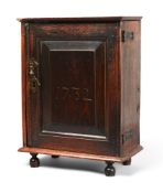 AN OAK SPICE CUPBOARD, SECOND HALF 18TH CENTURY, BEARING DATE 1732