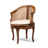 A CARVED WALNUT AND CANED DESK CHAIR, FRENCH, LATE 19TH OR EARLY 20TH CENTURY