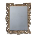 A LARGE CARVED SOFTWOOD, PROBABLY LIME, WALL MIRROR, LATE 17TH OR EARLY 18TH CENTURY AND LATER