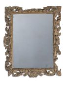 A LARGE CARVED SOFTWOOD, PROBABLY LIME, WALL MIRROR, LATE 17TH OR EARLY 18TH CENTURY AND LATER