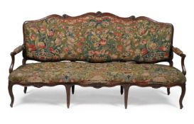 A CARVED WALNUT AND NEEDLEWORK UPHOLSTERED SOFA OR CANAPE, IN LOUIS XV STYLE, FRENCH, 19TH CENTURY