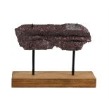 A CARVED FRAGMENT OF IMPERIAL PORPHYRY