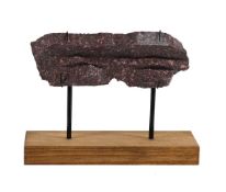 A CARVED FRAGMENT OF IMPERIAL PORPHYRY