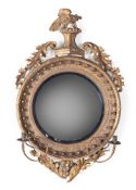 A REGENCY GILTWOOD AND EBONISED CONVEX GIRANDOLE MIRROR, CIRCA 1815 AND LATER