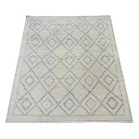 A LARGE CREAM AND BLUE GEOMETRIC CARPET