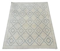 A LARGE CREAM AND BLUE GEOMETRIC CARPET