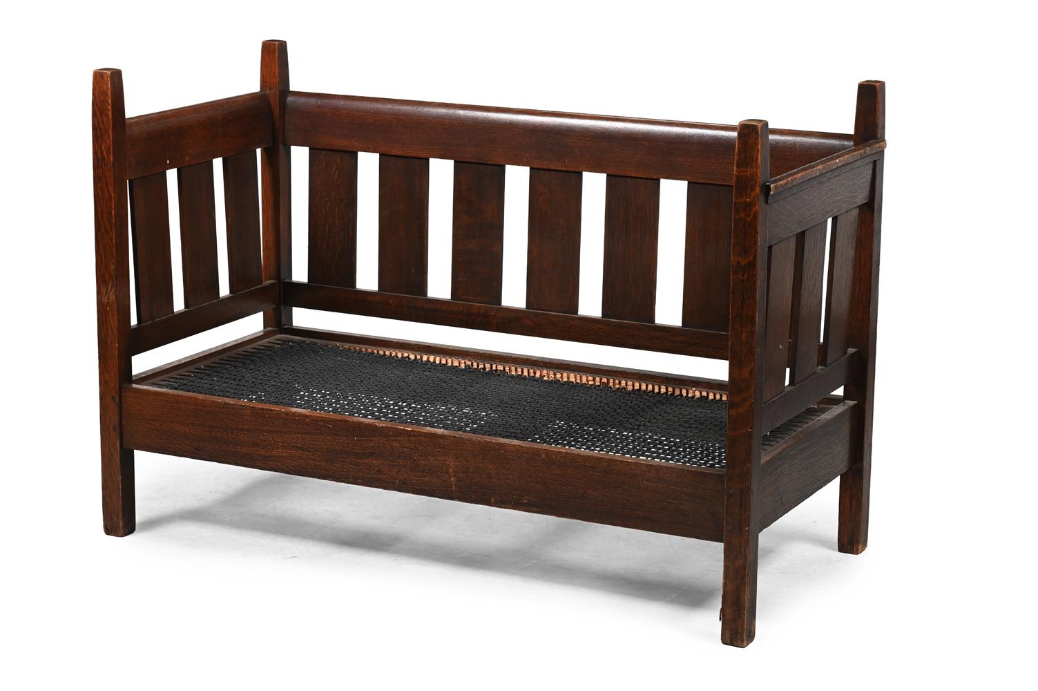 AN ARTS AND CRAFTS OAK SETTLE, POSSIBLY AMERICAN, IN THE MANNER OF THE STICKLEY BROTHERS, CIRCA 1900