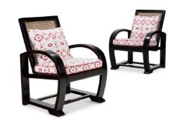 A PAIR OF EBONISED 'STEAMER STYLE' OPEN ARMCHAIRS, PROBABLY ASIAN