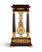A RARE FRENCH EMPIRE ORMOLU AND FIGURED MAHOGANY OSCILLATING PORTICO MANTEL REGULATOR
