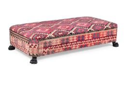 A KILIM UPHOLSTERED OTTOMAN