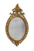 A FINE GEORGE III CARVED GILTWOOD OVAL MIRROR, IN THE MANNER OF THOMAS CHIPPENDALE, CIRCA 1770