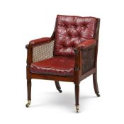 A REGENCY MAHOGANY BERGERE LIBRARY ARMCHAIRIN THE MANNER OF GILLOWS