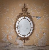 A LARGE GEORGE III CARVED GILTWOOD MIRROR, AFTER DESIGNS BY ROBERT ADAM, CIRCA 1780