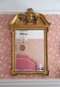 A GEORGE II CARVED GILTWOOD MIRROR, CIRCA 1735