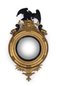 A REGENCY GILTWOOD, GESSO AND EBONISED CONVEX MIRROR, CIRCA 1820