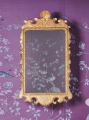 A GEORGE I CARVED GILTWOOD MIRROR, CIRCA 1720