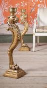 A PAIR OF CARVED GILTWOOD LION MONOPODIA CANDLESTICKS, EARLY 19TH CENTURY AND LATER