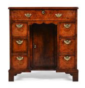 A GEORGE I BURR WALNUT AND FEATHERBANDED KNEEHOLE DESK, CIRCA 1720