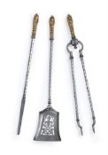 A SET OF THREE STEEL AND GILT BRASS FIRE TOOLS, EARLY 19TH CENTURY