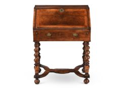 A WALNUT AND FEATHER BANDED WRITING DESK, IN EARLY 18TH CENTURY STYE