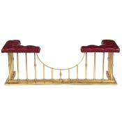 A POLISHED BRASS AND RED LEATHER UPHOLSTERED CLUB FENDER, 20TH CENTURY